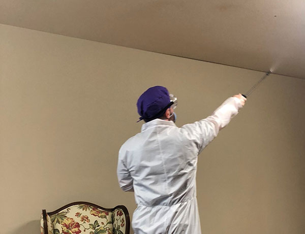 man electrostatic spraying the ceiling